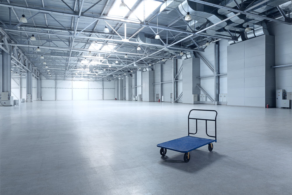 Interior of empty warehouse with a cart