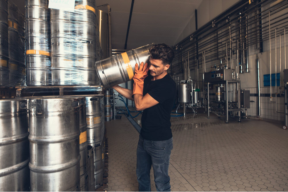  Young man working at warehouse in brewery